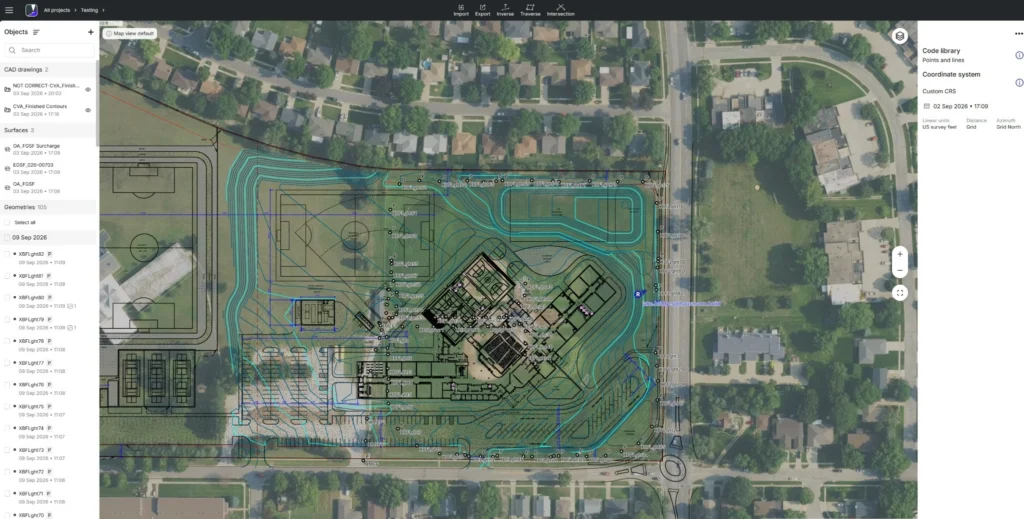 Aerial site plan overlaid on an aerial photograph showing buildings, athletic fields, parking areas, roads, sidewalks, property boundaries, and detailed turquoise topographic contour lines.